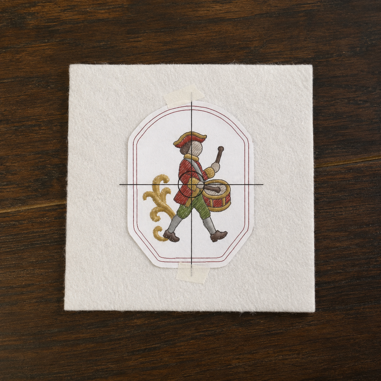 Printed ornament template positioned on white felt before cutting